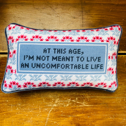 Quote from White Lotus Victoria Radcliff "At this age, I'm not meant to live an uncomfortable life" on Furbish Needlepoint Pillow